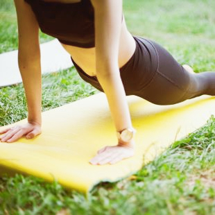 Stock photo of woman doing yoga pose outdoors.